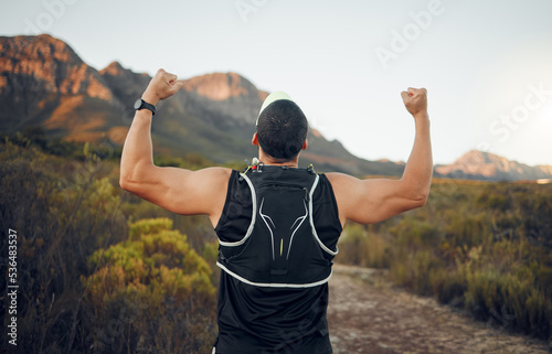 Winner  mountain and runner man success with back view celebrating cardio exercise goal victory. Muscular  strong and fitness lifestyle male running achievement celebration in South African bush.