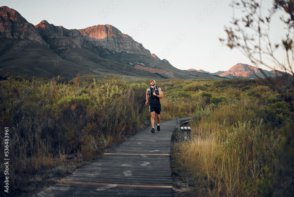 Health, man runner and in nature for training, wellness and fitness outdoor in the morning in sportswear. Exercise, male athlete, running on trail and workout warm up to be healthy and do cardio.