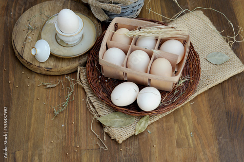 Raw chicken eggs in authentic egg box on a kitchen photo