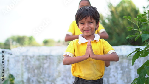 Cute asian student pay respect or sawasdee to prayers with devotion. Indian culture photo