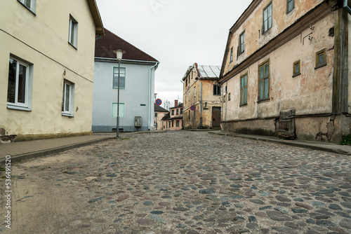 Street in small town with cobblestone road.