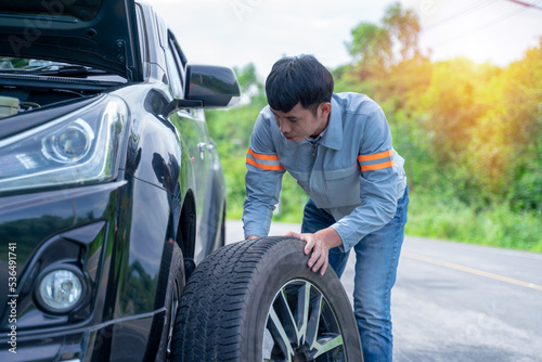 Handsome mechanic. Car inspection and roadside car repair service.