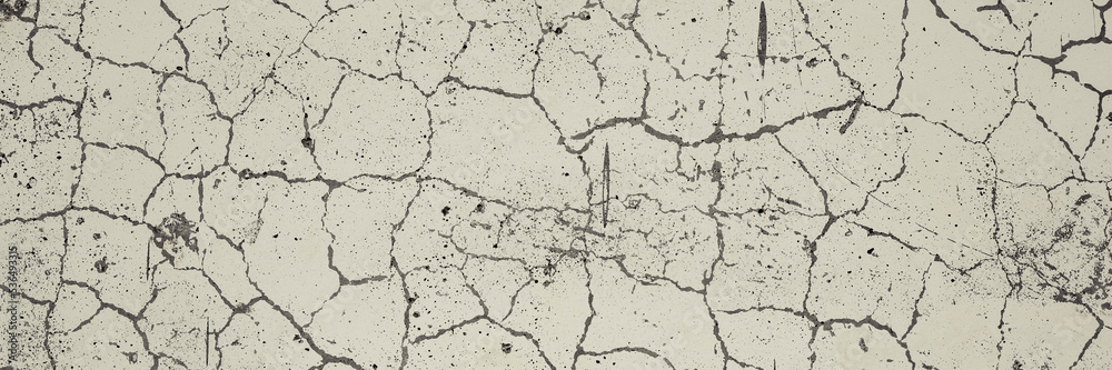 Cracked concrete wall texture. Weathered rough surface. Gray and white color. Panoramic background for grunge design.