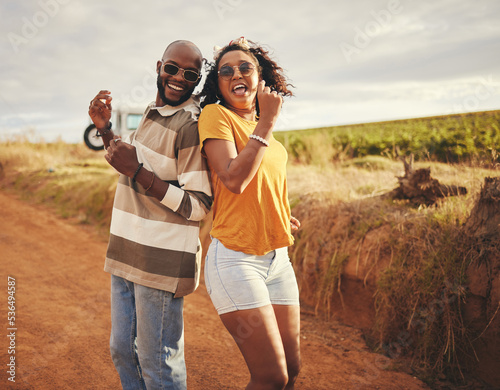 Friends, fun and dance on vacation during travel in countryside in Texas on dirt road in summer. Black man and woman dancing, freedom and smile during journey, adventure and holiday in rural area