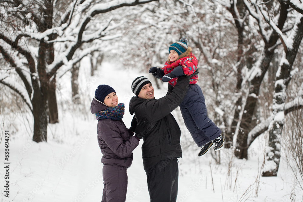 Happy family playing in winter forest Happy family playing in winter forest