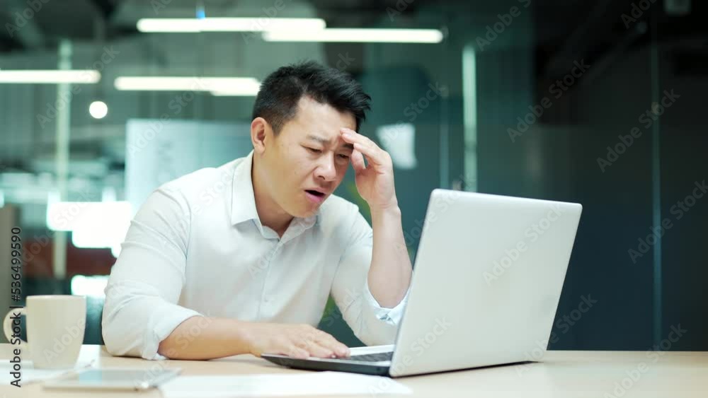 Dissatisfied with the results businessman looking at laptop computer screen in the office. Angry mature asian business man employee attorney analyst manager worker bad work fail and failure online Dissatisfied with the results businessman looking at laptop computer screen in the office. Angry mature asian business man employee attorney analyst manager worker bad work fail and failure online