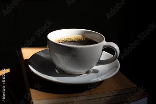 A coffee cup on a dark wooden background
