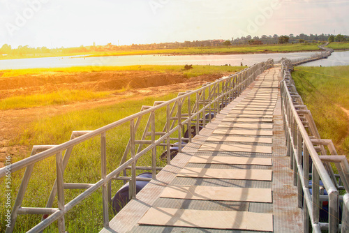 Bridge over the river with bright sky and bright sunset