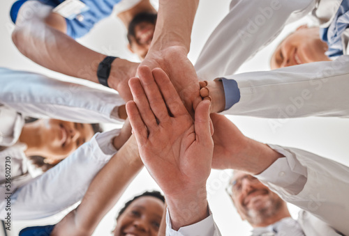 Hands, doctor and teamwork below in hospital for motivation, inspiration and diversity at work. Medical, team and hand together in collaboration at clinic, help community in healthcare and wellness