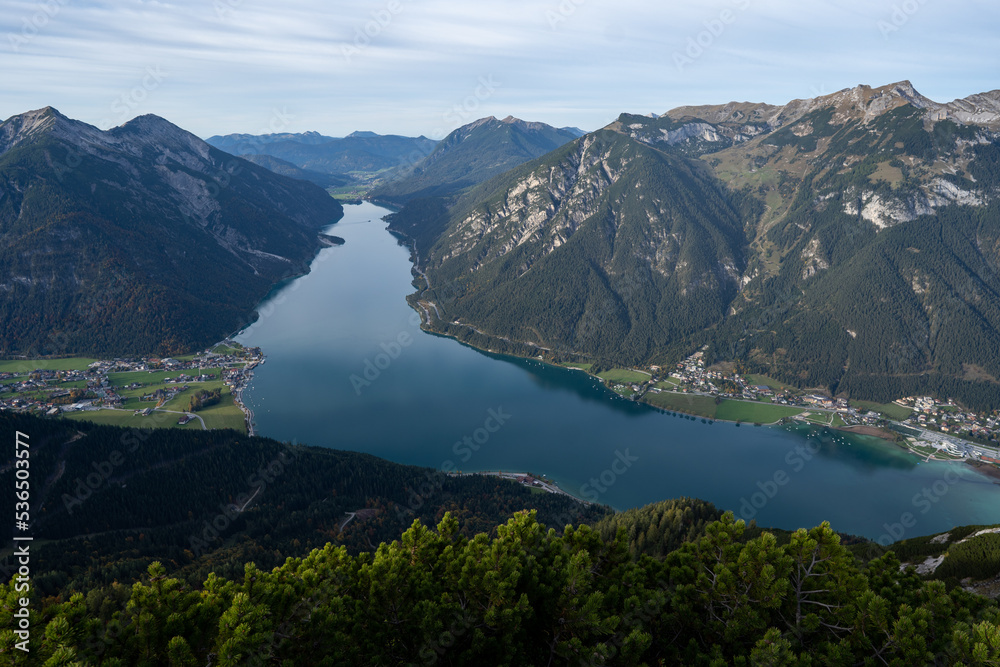 Beautiful panoramic view of the Achensee from Barenkopf rock during sunset in autumn with dramatic sky. Tyrol, Austria in it's beauty surrounded with mountains