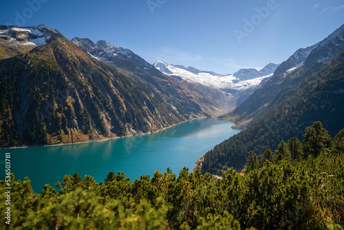 The bow shaped turquoise Schlegeisspeicher lake with the glacier in Tyrol photo
