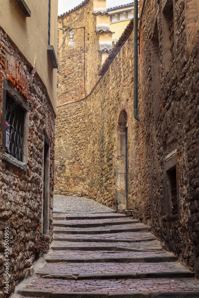 Fototapeta premium Paved road with appartment buildings and architecture in Bergamo, Italy