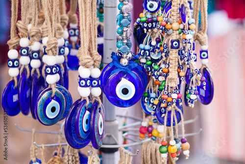 Nazar boncuk amulets (wards against the evil eye) hanging in the row at grid, Arasta Bazaar, Istanbul. Closeup shot
