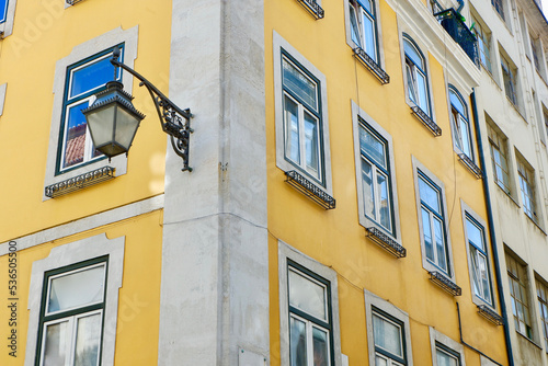 Corner of the classical Portuguese building of yellow and grey colours downtown in Lisbon, Portugal