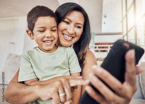 Selfie, mother and son phone in living room on sofa smile, together and happiness on smartphone. Happy mom, boy child or kid love to watch internet online film or video streaming mobile app at home