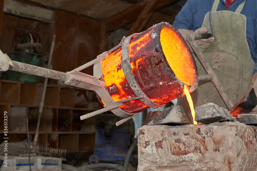Artist casting bronze and pouring melting Stock Photo | Adobe