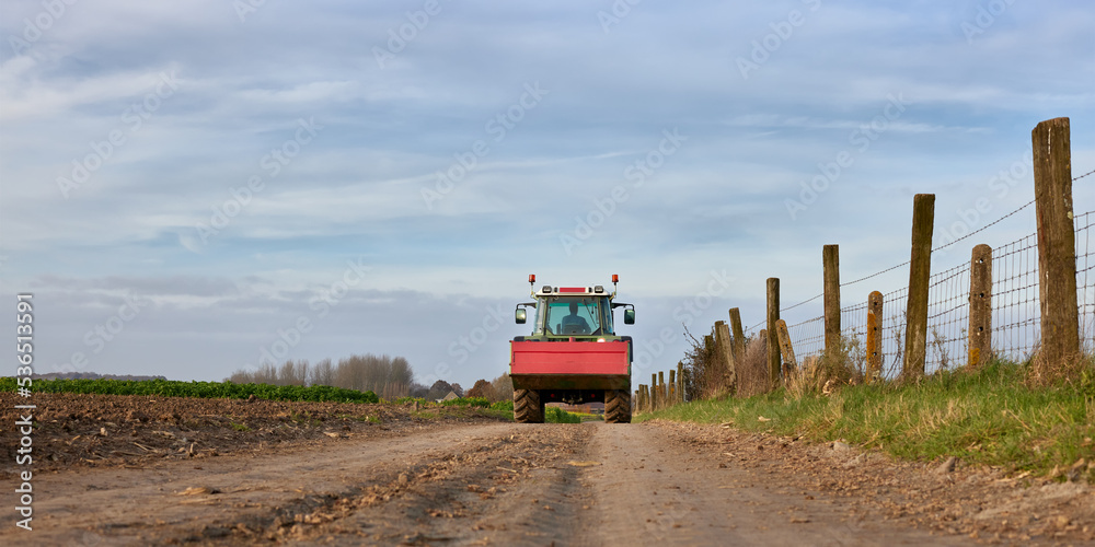 Tractor on country road after harvest Tractor on country road after harvest