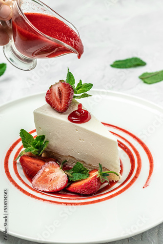 Fototapeta Naklejka Na Ścianę i Meble -  delicious homemade strawberry cheesecake with fresh strawberries, jam and mint