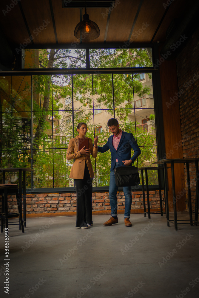 A business couple is leaving the coffee bar A business couple is leaving the coffee bar