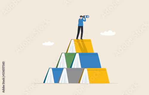 The way forward. Knowledge of the future.  Knowledge gained from education. Skill development for career or business. reading success. Businessmen on stacks of great books for good vision.