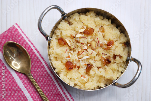 Rava Sheera or Suji ka halwa, shira is an indian sweet dish, made with semolina, sugar, ghee and dry fruits. served as dessert or as Prasad during festivals. Garnished with saffron. Copy space. photo