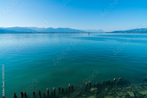 Germany, Bodensee lake view to austrian alps mountains coast beautiful clear water of lake constance with blue sky in summer