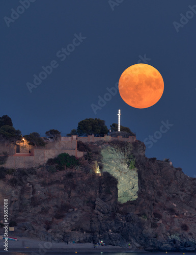 almuñecar, spain, september 9 -2022 full moon rising over the rocks of San Francisco also called San Cristobal