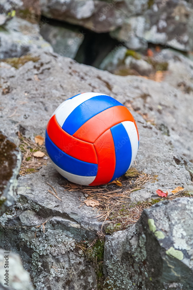 Volleyball ball close-up on the background of a stone cliff in autumn