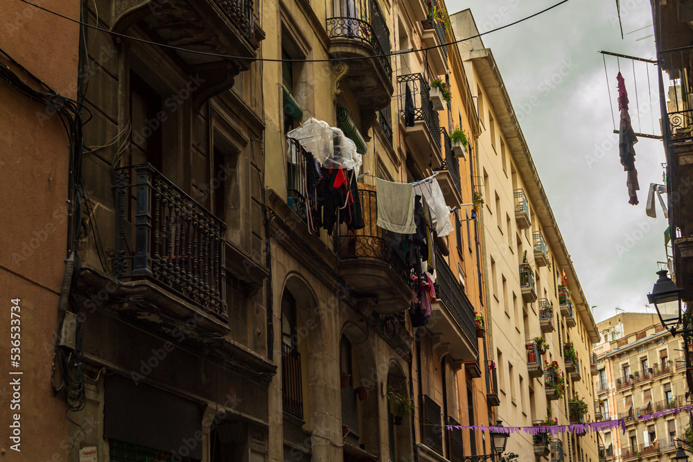 Barcelona street with washing hanging from balcony to dry and air
