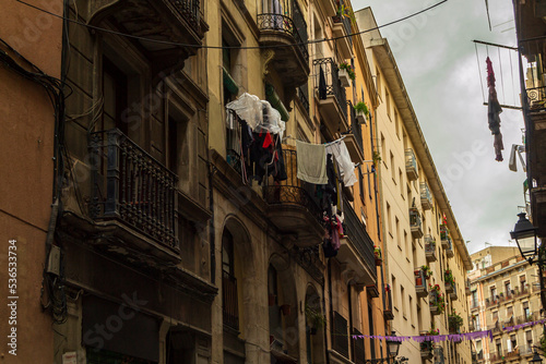 Fototapeta Naklejka Na Ścianę i Meble -  Barcelona street with washing hanging from balcony to dry and air
