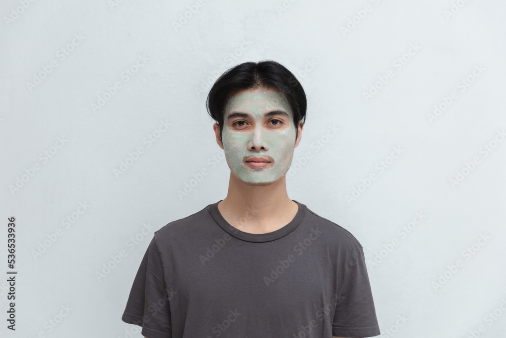 Attractive Asian men with female face anti-acne clay mask to rejuvenate the skin. Attractive Asian men with female face anti-acne clay mask to rejuvenate the skin.