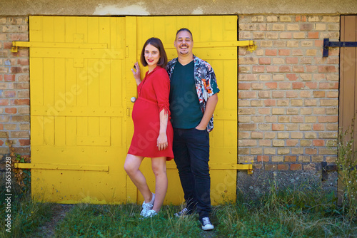 Lovely pregnant couple walking in a park