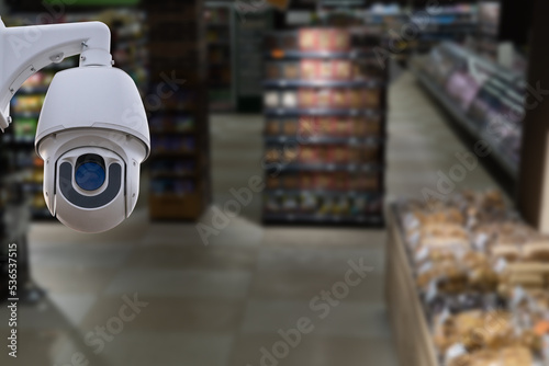 CCTV system security and blurred defocused background of supermarket interior