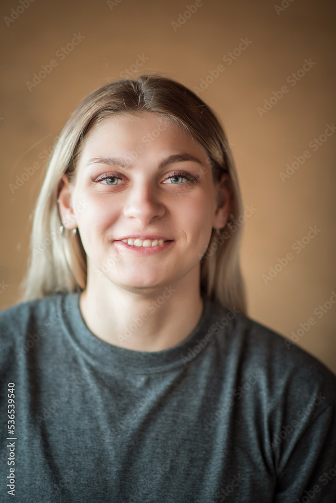 Close-up portrait of a young beautiful fair-haired girl with an interesting expression on her face. Close-up portrait of a young beautiful fair-haired girl with an interesting expression on her face.