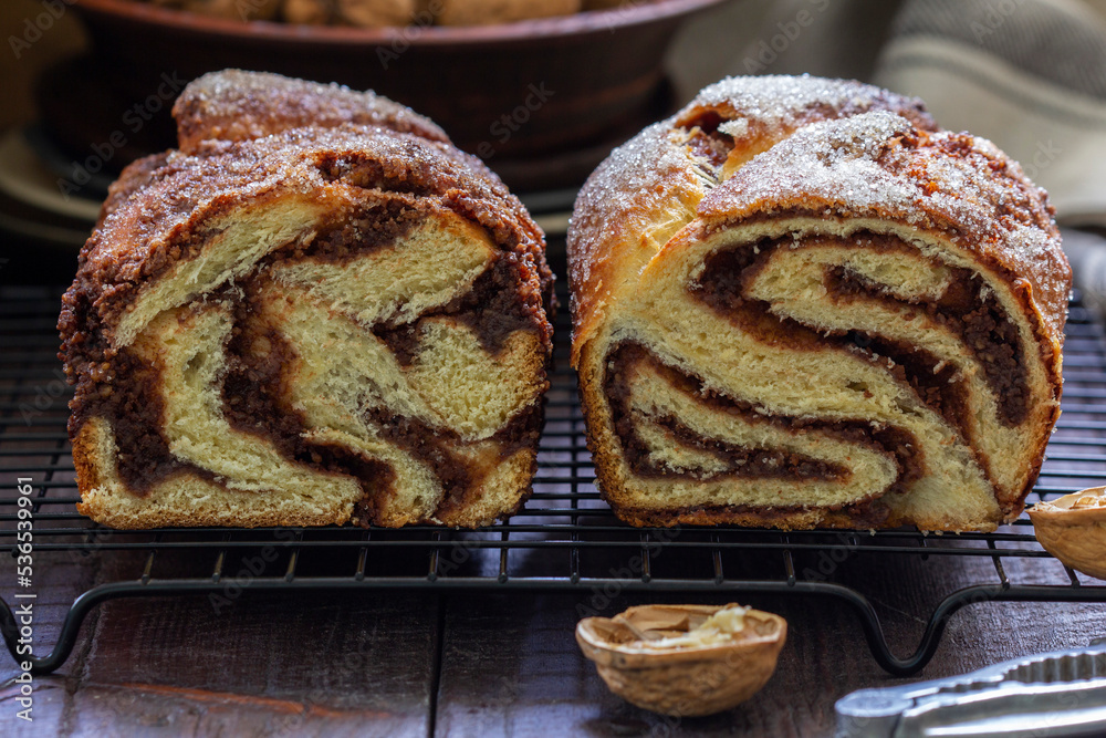 Traditional Easter bread with chocolate and nut filling on a wooden background.