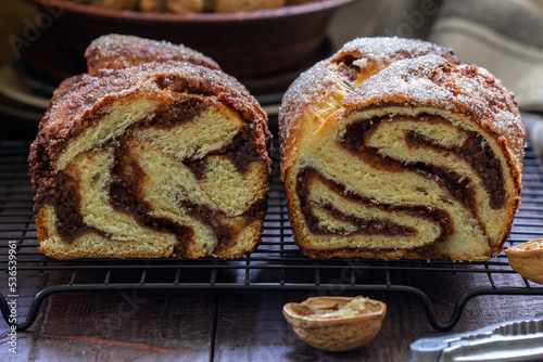Obraz na płótnie Traditional Easter bread with chocolate and nut filling on a wooden background. w salonie