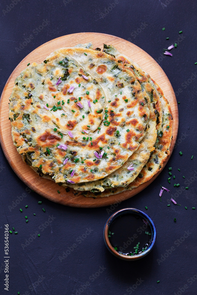Homemade appetizing scallion pancakes served with soy sauce.