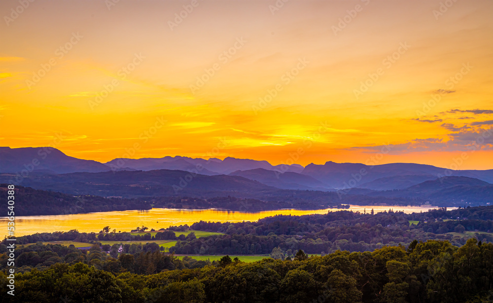 View of sunset over Windermere in Lake District, a region and national park in Cumbria in northwest England View of sunset over Windermere in Lake District, a region and national park in Cumbria in northwest England