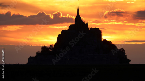 breathtaking silhouette of the abbey of Mont Saint Michel in France at sunset
