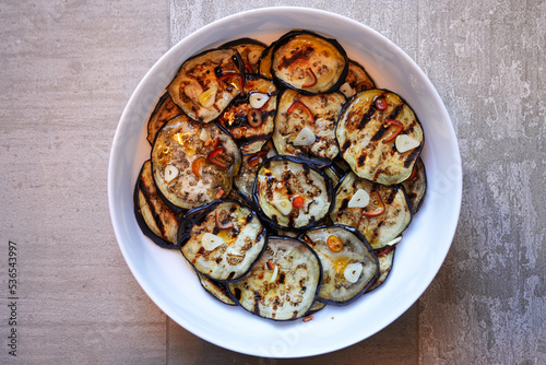 Tasty Italian homemade dish during autumn season, made of grilled eggplant, garlic, hot pepper and olives oil. Traditional Italian recipes.