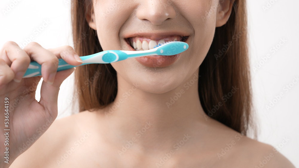 Beauty concept of 4k Resolution. Asian woman brushing teeth on a white background. Beauty concept of 4k Resolution. Asian woman brushing teeth on a white background.