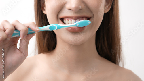 Beauty concept of 4k Resolution. Asian woman brushing teeth on a white background.