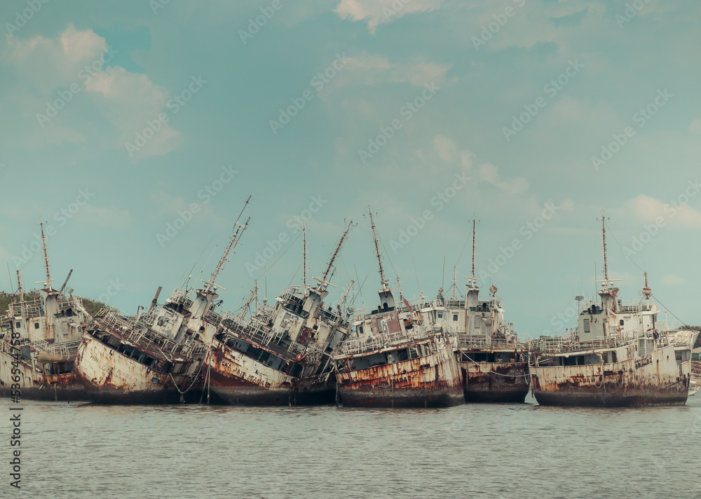 Several Phinisi shipwrecks just piled up in the waters of the port of Paotere, Makassar, Indonesia. Several Phinisi shipwrecks just piled up in the waters of the port of Paotere, Makassar, Indonesia.
