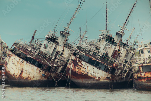 Several Phinisi shipwrecks just piled up in the waters of the port of Paotere, Makassar, Indonesia. photo
