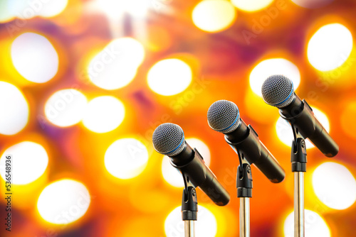 Microphones Public speaking background, Close up microphone on stand for speaker speech presentation stage performance or press conference backgrounds. photo
