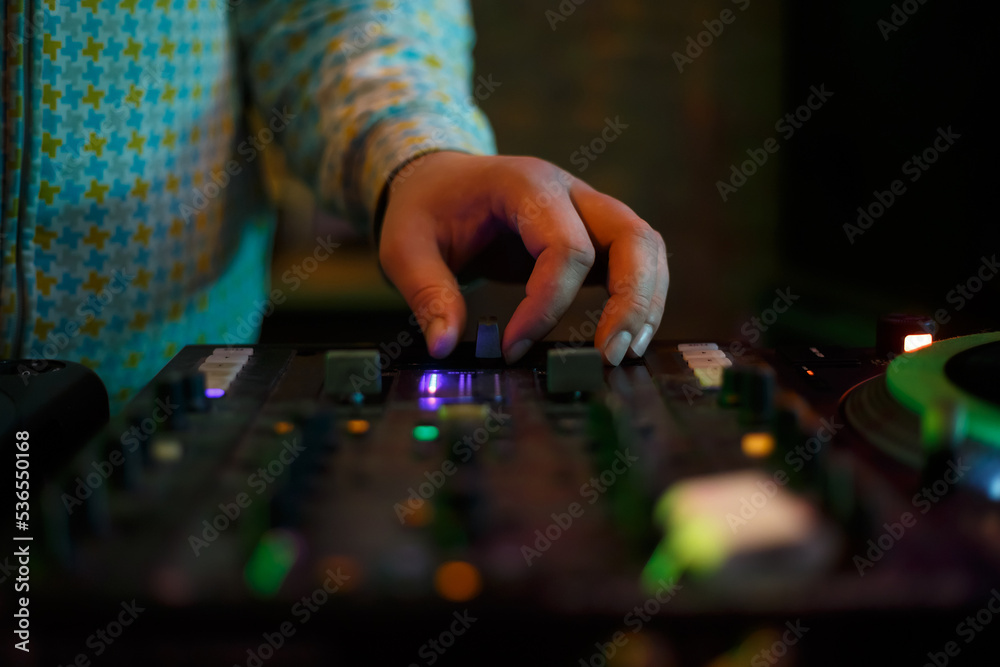 Hip hop dj plays music with sound mixer. Hand of disc jockey on cross fader  knob. Professional disk jokey mixing musical tracks on party in night club  Photos | Adobe Stock