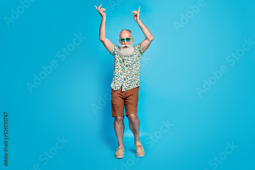 Full body size photo of old aged white hair gray bearded man senior fingers up dance hipster feel young himself relaxed isolated on blue color background