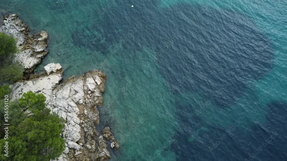 rocky sea coast, calm sea, view from a drone from a low height, early autumn, you can see the seabed in the clear sea rocky sea coast, calm sea, view from a drone from a low height, early autumn, you can see the seabed in the clear sea