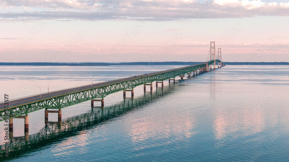 Aerial view on the Mackinac Bridge in the morning over calm water