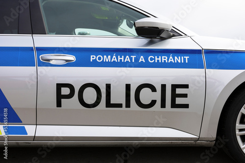 Police of Czechia and Czech Republic, detail of car. Czech text on vehicle (translation: Help and protect. Police). Public service for protection against criminality and criminals.